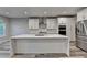 Modern kitchen featuring an island with a marble countertop and stainless steel appliances at 194 Jennifer Nw Ln, Lilburn, GA 30047