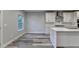 Bright kitchen featuring white cabinets, stainless appliances, and a spacious eat-in area with grey vinyl flooring at 194 Jennifer Nw Ln, Lilburn, GA 30047