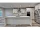 Modern kitchen featuring an island with a marble countertop and stainless steel appliances at 194 Jennifer Nw Ln, Lilburn, GA 30047