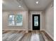 Bright living room with hardwood floors, white trim, and natural light from large windows at 194 Jennifer Nw Ln, Lilburn, GA 30047