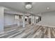 Spacious living room with fireplace, open layout connecting to the kitchen, and modern flooring at 194 Jennifer Nw Ln, Lilburn, GA 30047