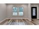 Living room featuring lots of natural light, hardwood floors, and large windows at 194 Jennifer Nw Ln, Lilburn, GA 30047