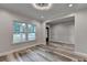 Living room with hardwood floors, white trim, and a modern light fixture at 194 Jennifer Nw Ln, Lilburn, GA 30047