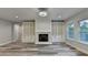 Cozy living room showcasing a fireplace, built-in bookcases, and hardwood floors for a warm and inviting space at 194 Jennifer Nw Ln, Lilburn, GA 30047