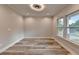 Living room showcasing a modern light fixture, large windows, and neutral walls at 194 Jennifer Nw Ln, Lilburn, GA 30047
