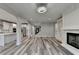 Open-concept living room connecting to kitchen and staircase, featuring stylish flooring and an airy atmosphere at 194 Jennifer Nw Ln, Lilburn, GA 30047