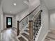 Staircase with wrought iron railing, hardwood steps, and a view of the front door at 194 Jennifer Nw Ln, Lilburn, GA 30047