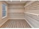Spacious walk-in closet with built-in storage and hardwood style floors at 194 Jennifer Nw Ln, Lilburn, GA 30047