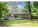 A cozy single-story house from the backyard with a concrete patio and lush green lawn at 2044 Glendale Dr, Decatur, GA 30032
