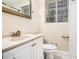 Bathroom featuring a white vanity with storage, a toilet, and a shower with white tiling at 2044 Glendale Dr, Decatur, GA 30032