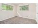 Light-filled bedroom with two windows offering green views, and neutral carpet at 2044 Glendale Dr, Decatur, GA 30032