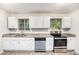Updated kitchen featuring white cabinets, granite countertops, and stainless steel appliances at 2044 Glendale Dr, Decatur, GA 30032