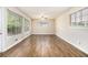 Sunlit living room with gleaming hardwood floors and multiple windows at 2044 Glendale Dr, Decatur, GA 30032