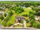 Aerial view of a large estate home with manicured landscaping, circular driveway, and surrounding greenery at 2855 Drayton Hall Dr, Buford, GA 30519