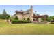 Expansive backyard featuring a covered patio with outdoor furniture and a lush green lawn at 2855 Drayton Hall Dr, Buford, GA 30519