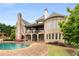 An exterior rear view of a brick home with a pool and lounge chairs at 2855 Drayton Hall Dr, Buford, GA 30519