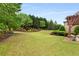 Spacious backyard with lush landscaping, a pergola, and a well-maintained lawn at 2855 Drayton Hall Dr, Buford, GA 30519