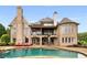 Luxury home boasts a stunning pool, outdoor lounge area, and beautifully landscaped backyard at 2855 Drayton Hall Dr, Buford, GA 30519