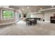 Large finished basement area with neutral carpet, game table, and plenty of natural light from the large windows at 2855 Drayton Hall Dr, Buford, GA 30519