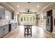 Basement kitchenette featuring a breakfast bar, grey shaker cabinets, stainless steel refrigerator, and backyard views at 2855 Drayton Hall Dr, Buford, GA 30519