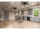 Modern basement kitchenette featuring grey cabinetry, stainless steel appliances, and stylish sliding barn doors at 2855 Drayton Hall Dr, Buford, GA 30519