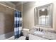 Bathroom with granite countertop, patterned shower curtain, and framed mirror at 2855 Drayton Hall Dr, Buford, GA 30519