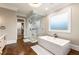 Elegant bathroom featuring a glass shower, soaking tub, and access to a walk-in closet at 2855 Drayton Hall Dr, Buford, GA 30519