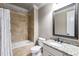 Bathroom featuring a granite countertop, tiled shower, and a framed mirror at 2855 Drayton Hall Dr, Buford, GA 30519