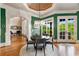 Elegant dining area featuring a modern chandelier, French doors, and views of the outdoor space at 2855 Drayton Hall Dr, Buford, GA 30519