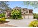 Elegant brick and stone home featuring a three-car garage and meticulously landscaped front yard at 2855 Drayton Hall Dr, Buford, GA 30519