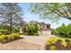 Elegant brick and stone home featuring a three-car garage and meticulously landscaped front yard at 2855 Drayton Hall Dr, Buford, GA 30519