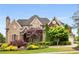 Stunning brick home with beautifully landscaped front yard and a three-car garage at 2855 Drayton Hall Dr, Buford, GA 30519