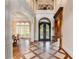 Inviting foyer with archways, hardwood flooring, and iron-wrought doors, plus beautiful light at 2855 Drayton Hall Dr, Buford, GA 30519