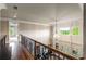 Open hallway with detailed railing overlooking a living room filled with lots of natural light at 2855 Drayton Hall Dr, Buford, GA 30519