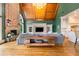 Open-concept living room with vaulted wood ceilings, hardwood floors, stone fireplace and ample seating at 2855 Drayton Hall Dr, Buford, GA 30519