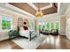 Large primary bedroom suite featuring a tray ceiling, sitting area, and plenty of natural light at 2855 Drayton Hall Dr, Buford, GA 30519