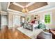 Luxurious main bedroom with elegant chandelier, tray ceiling, and access to ensuite bathroom at 2855 Drayton Hall Dr, Buford, GA 30519