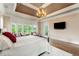Relaxing main bedroom featuring a large bed, chandelier, TV and windows at 2855 Drayton Hall Dr, Buford, GA 30519