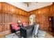 A charming office with wood paneling, a patterned rug, and ample natural light at 2855 Drayton Hall Dr, Buford, GA 30519