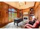 Executive office with wood paneling, built-in bookshelves, and a cozy fireplace is perfect for remote work at 2855 Drayton Hall Dr, Buford, GA 30519