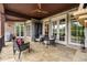 Relaxing outdoor patio featuring stone flooring, a ceiling fan, and ample seating around a fireplace at 2855 Drayton Hall Dr, Buford, GA 30519