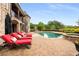 Luxury home featuring a stunning pool area with lounge chairs and a nearby outdoor seating area at 2855 Drayton Hall Dr, Buford, GA 30519