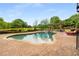Beautiful kidney-shaped pool surrounded by lush greenery and a pergola-covered lounge area at 2855 Drayton Hall Dr, Buford, GA 30519