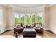 Cozy sitting area with bay windows, two armchairs, ottoman, and wood floors at 2855 Drayton Hall Dr, Buford, GA 30519