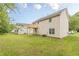 Home featuring a wooden deck, set against a backdrop of a lush green lawn at 3022 Stonebridge Creek Dr, Lithonia, GA 30058