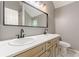 Modern bathroom with double sink vanity, updated fixtures, and framed mirror at 3022 Stonebridge Creek Dr, Lithonia, GA 30058
