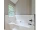 Bright bathroom featuring a white subway tiled accent wall and a soaking tub with bronze fixtures at 3022 Stonebridge Creek Dr, Lithonia, GA 30058