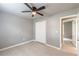 Bedroom with modern ceiling fan, neutral walls, and closet for ample storage at 3022 Stonebridge Creek Dr, Lithonia, GA 30058