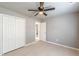 Spacious bedroom with modern ceiling fan, neutral paint, and closet space at 3022 Stonebridge Creek Dr, Lithonia, GA 30058