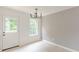 Cozy dining area featuring light wood floors, backyard access, and modern lighting at 3022 Stonebridge Creek Dr, Lithonia, GA 30058